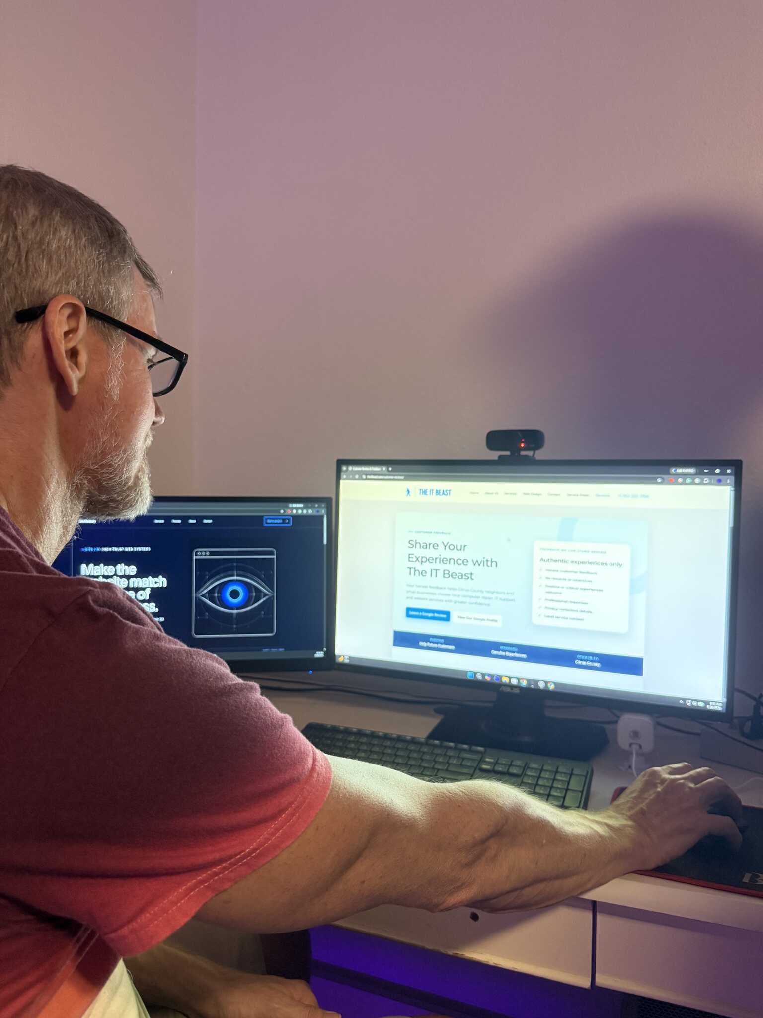 The IT Beast technician working at a dual-monitor computer workstation