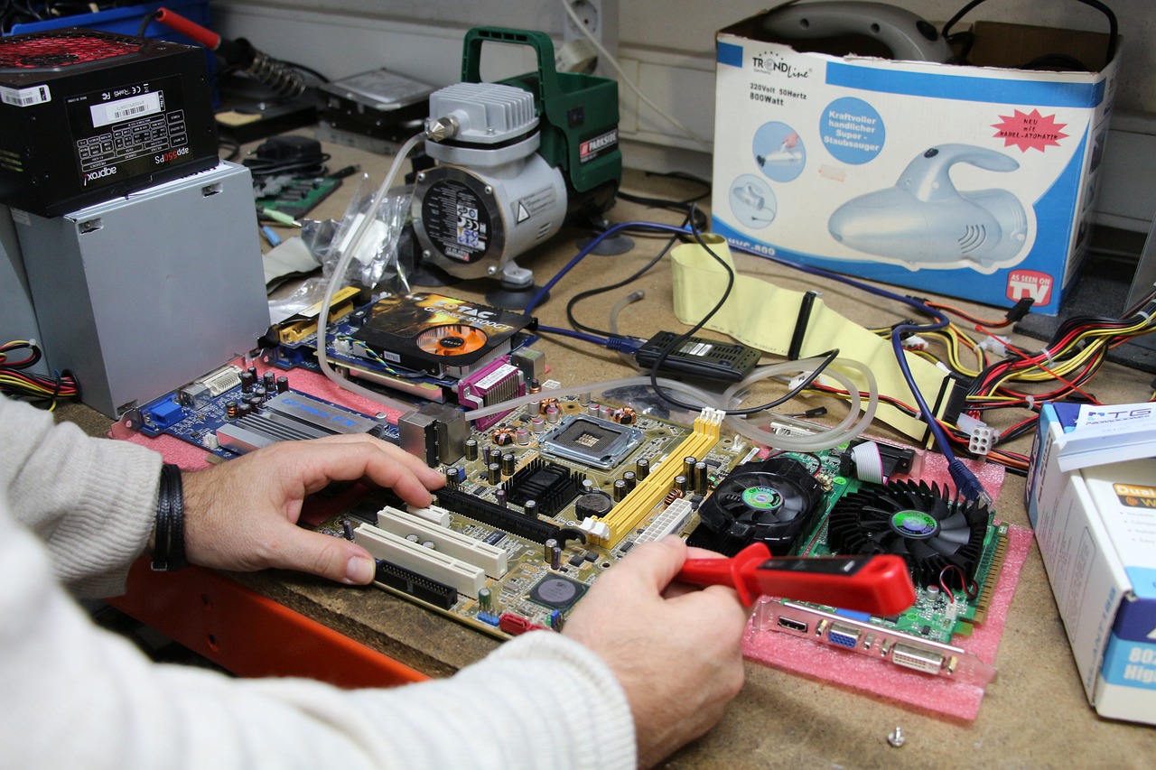 Computer repair technician testing a desktop motherboard